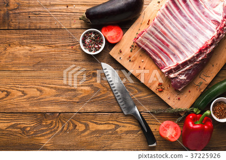 Raw rack of lamb on wooden board 37225926