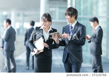 Innocent adult business man and woman two businessmen Business scene Office scene Innocent adult business man and woman two businessmen Business scene Office scene 37228788
