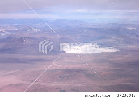 Saltwater lakes dotted in the Andes mountain range that runs the South American continent from north to south, mountains in the early summer seen from above Chile, and high altitude deserts 37230015