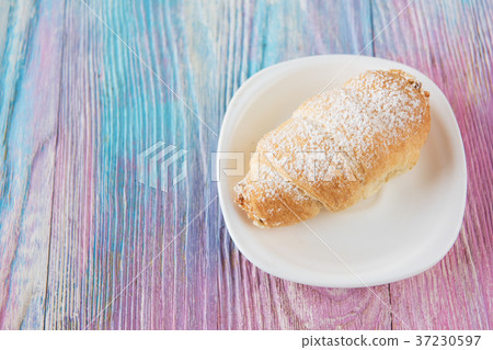 Tasty eclair on plate Tasty eclair on plate 37230597