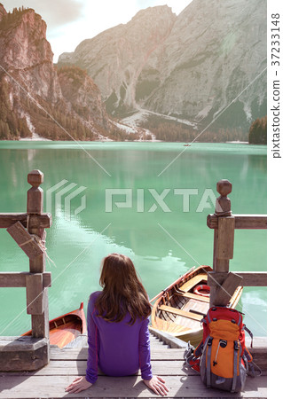 girl backpacker looking at Braies lake 37233148