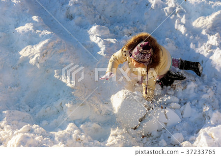 Cute little girl having fun in snowfall. Cute little girl having fun in snowfall. 37233765