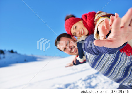 Loving couple playing together in snow outdoor. 37239596