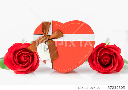 Close up red rose and heart-shaped box on white Close up red rose and heart-shaped box on white 37239805