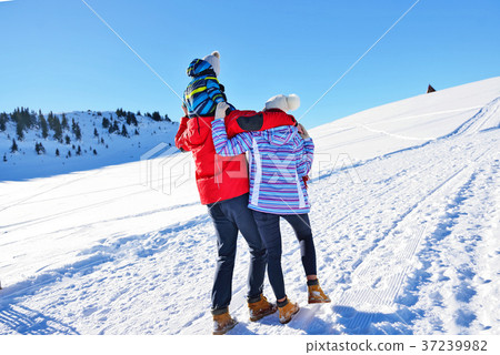 happy young family playing in fresh snow at 37239982