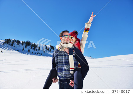 Young couple having fun on snow. Happy man at the Young couple having fun on snow. Happy man at the 37240017