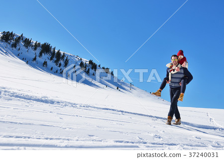 Young couple having fun on snow. Happy man at the Young couple having fun on snow. Happy man at the 37240031