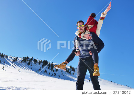 Young couple having fun on snow. Happy man at the Young couple having fun on snow. Happy man at the 37240042