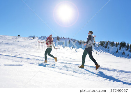 Couple having fun running down slope Couple having fun running down slope 37240067
