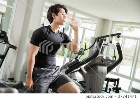 Asian men are drinking clean water While cycling Asian men are drinking clean water While cycling 37241471