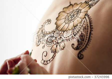 Beautiful henna patterns in process of applying 37243996