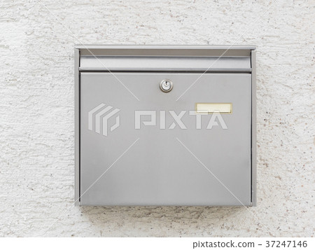 A silver mailbox on the wall A silver mailbox on the wall 37247146
