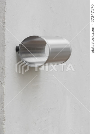 A silver box for newspapers on the wall A silver box for newspapers on the wall 37247170