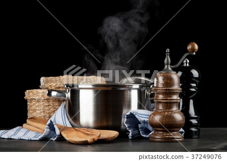 Steaming pot on black background Steaming pot on black background 37249076