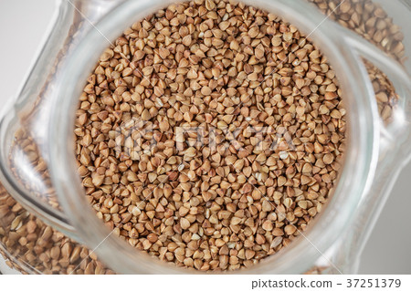 Uncooked up of raw buckwheat in glass jar Uncooked up of raw buckwheat in glass jar 37251379