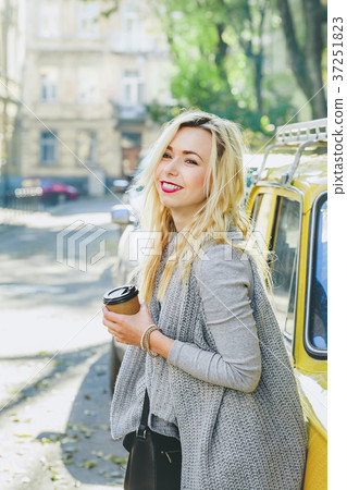 Young stylish woman drinking coffee on the street Young stylish woman drinking coffee on the street 37251823