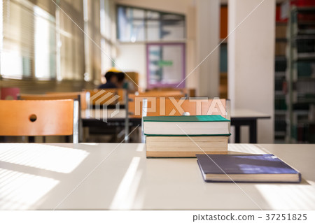 textbooks on table in library 37251825