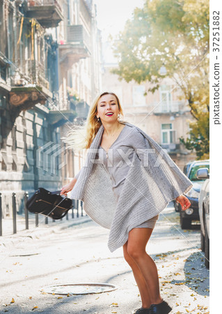 Young stylish woman walking on the city street Young stylish woman walking on the city street 37251882