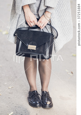 Woman legs wearing black shoes on the street Woman legs wearing black shoes on the street 37251884
