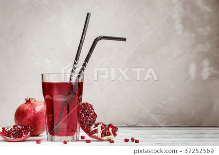 Glass with pomegranate juice and fresh fruit 37252569
