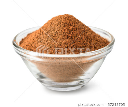 Glass bowl of ground cinnamon Glass bowl of ground cinnamon 37252705