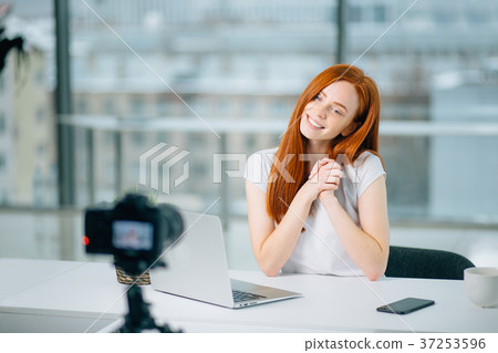 Young woman recording video on camera mounted on Young woman recording video on camera mounted on 37253596