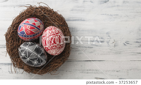Easter eggs in the nest on wooden background Easter eggs in the nest on wooden background 37253657