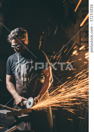 man using angle grinder sparks 37253856