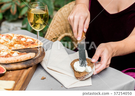 Female hands make sandwich of rye bread and cheese Female hands make sandwich of rye bread and cheese 37254050
