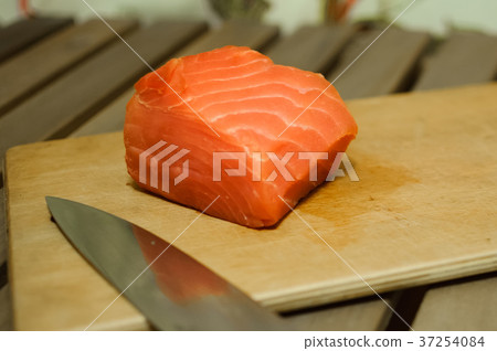 Piece of salmon fillet on cutting board 37254084