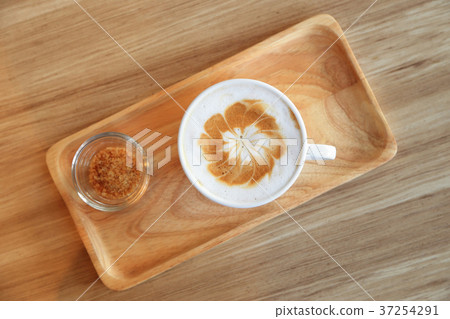 Cup of latte coffee with latte art and brown sugar Cup of latte coffee with latte art and brown sugar 37254291