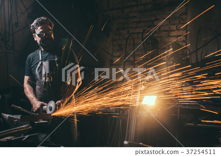 man Using Angle Grinder in Factory and throwing 37254511