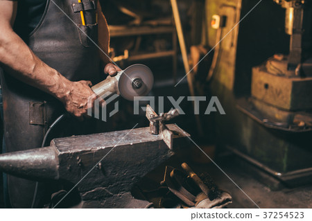man Using Angle Grinder in Factory and throwing 37254523