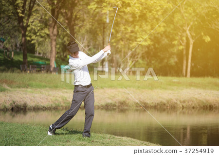 golf player swinging driver golf club  37254919