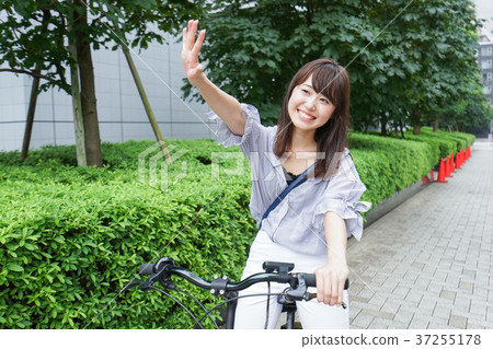 Woman riding a bicycle Woman riding a bicycle 37255178