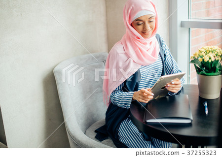 female Muslim college student using tablet 37255323