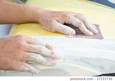 hand close up sanding in the work shop 37255750