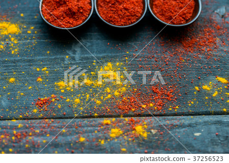 Studio shot of spoons with red paprika powder Studio shot of spoons with red paprika powder 37256523