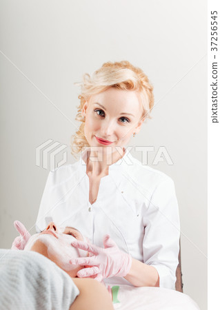 Positive professional cosmetologist is holding 37256545