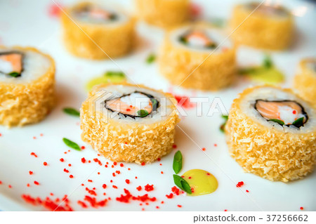 Sushi rolls scattered on white background Sushi rolls scattered on white background 37256662