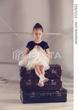 The little girl as balerina dancer sitting at The little girl as balerina dancer sitting at 37257622