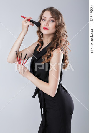 woman make-up artist with natural make-up holding 37259822