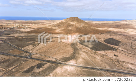 Aerial view of desert road volcano panorama by sea Aerial view of desert road volcano panorama by sea 37260282