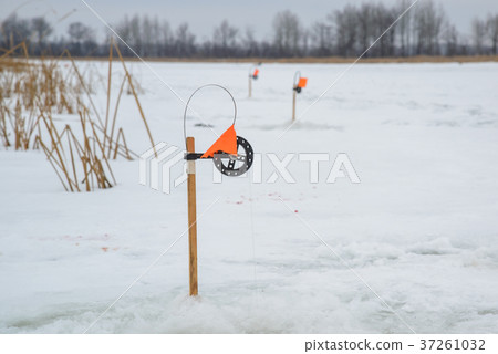 Winter fishing rod close up, tip-up with reel and 37261032