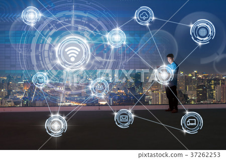 Asian technician engineer standing and using the laptop showing Wireless communication connecting of smart city Internet of Things Technology over the cityscape, technology and innovation concept Asian technician engineer standing and using the laptop showing Wireless communication connecting of smart city Internet of Things Technology over the cityscape, technology and innovation concept 37262253