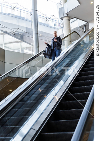Businesswoman with large black bag and mobile Businesswoman with large black bag and mobile 37264328