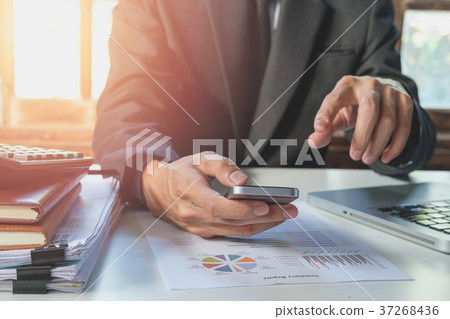 Businessman working and using smart phone Businessman working and using smart phone 37268436