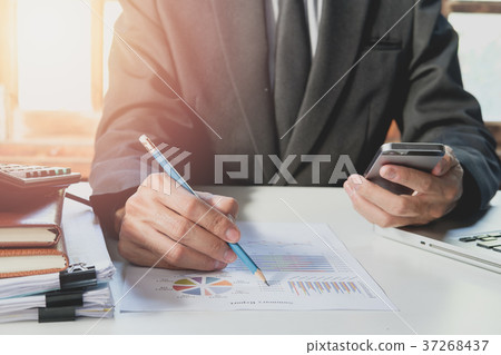Businessman hand working with finances  37268437