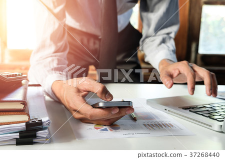 Businessman working and using smart phone Businessman working and using smart phone 37268440
