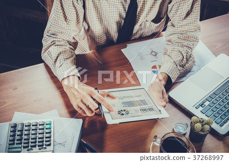Businessman working with digital tablet Businessman working with digital tablet 37268997